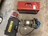 Photo showing all main components: Craftsman toolbox, DeWalt case, Craftsman bench grinder, Makita drill, Allen wrench set container, and saw blade.
