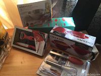 Overview of boxed kitchen items including 3-piece prep set, gadget set, and Crock-Pot bowls on wooden table