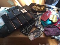 Overview of all bags, purses, and aprons on wooden table