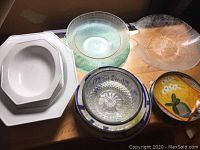 Overview of various serving bowls and platters showing materials and shapes