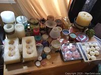 Selection of candles including white pillars, red and blue candles, floating and tea lights, multiple candle holders included.