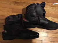 Side profile of black women's motorcycle boots with pink stitching, zipper and Velcro closure.