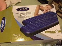 Box of Airest inflatable air bed showing product branding and features including 2-pack labeling but lot includes only one bed.