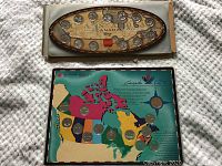 Two Canadian quarter sets, one on wooden oval frame from 1999 Millennium, another on colorful map for Canada 125 anniversary.