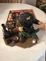 Front and side view of the Hagrid figurine showing detailed figure and props on a wooden floor base.