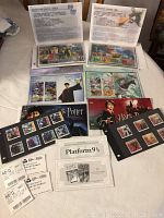 Overview photo showing six different Harry Potter stamp sets on original Canada Post cards, plus tickets and collector cards related to Harry Potter movie attendance and Platform 9 3/4 event.