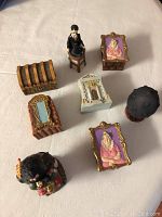 Closer angle showing 7 trinket boxes and the Harry Potter figurine on stool, with multiple pieces disassembled and details visible.