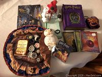 Photo showing entire Harry Potter bundle including games, puzzle notebook, key chains and notepad set arranged on white surface.