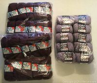 Two groups of yarn displayed side by side: right shows 10 sealed balls of Zara Chine Merino Extrafine in lilac; left shows 20 sealed balls of Naturally Karen M Luxury Double Knit in merlot.