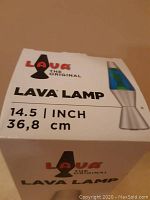 Box front showing Lava The Original brand, 14.5 inch size, image of lamp with silver base and blue liquid with green lava.