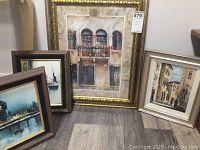 Group photo showing three framed painted artworks on the floor including the largest piece and two smaller paintings.