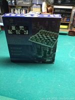 Photo of the product box showing the product name 'Drinking Chess' and an image of the chess board with shot glass pieces.