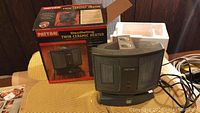 Patton Oscillating Twin Ceramic Heater shown with original box and styrofoam packaging on a table.