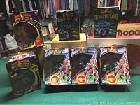 Seven boxed Power Rangers Full Space Aliens figures and Battle Bike models on green pool table surface.