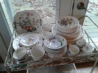 Full set arranged on metal rolling cart by window