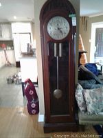 Full front view of entire longcase clock in interior setting