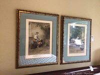 Two framed prints on wall, each 24x30 inches, showing a woman in period dress with doves in rustic setting.