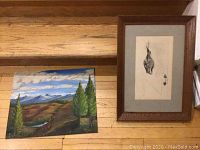 Photo showing both art pieces: acrylic landscape painting and framed brush sketch side by side on wooden steps.