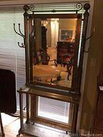 Front view of the antique brass hall coat rack with mirror and hooks, showing the full height and design.