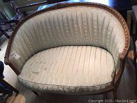 Front view of settee showing curved back and seat cushion