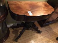 Table closed, top view showing mahogany finish and scalloped edge
