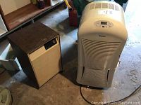 Photo of Danby and Westinghouse dehumidifiers side by side on floor, showing overall size and style.