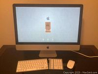 Front view of 27" iMac with wireless keyboard, numeric keypad and Magic Mouse on desk
