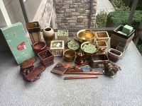 Photo showing full lot of ceramic and metal planters along with wind chimes, floral foam blocks visible in some planters, variety of shapes and sizes.