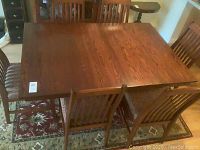 Angled view of full dining set showing table surface and four chairs