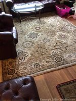 Full view of rectangular area rug under furniture in living room
