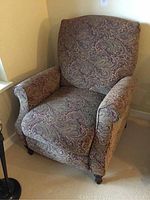 View of the chair from a side angle showing upholstery and armrest