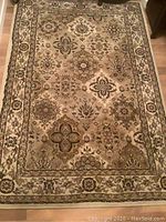 Full view of the rectangular area carpet showing the complete floral medallion design and border.