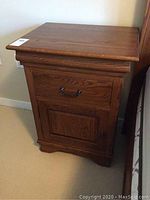 Nightstand front view showing drawer and cabinet door