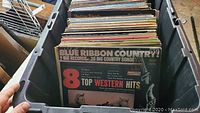 Photo showing bin of vinyl records with Blue Ribbon Country and other country albums visible
