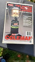 Original Coleman box showing graphic and product details: two mantle propane pressure regulated lantern with easy adjustment and disposable propane cylinder compatibility.