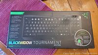 Front of the original product box showing Razer BlackWidow Tournament Edition keyboard image and key highlights