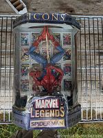 Front view of Spider-Man action figure in original Marvel Legends Icons box with comic cover backdrop.