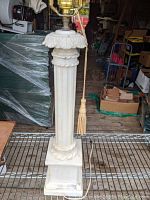 Front view of the alabaster lamp base showing carved details and the square base.