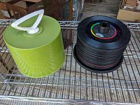 Avocado green Disc-Go record carrying case alongside stack of 45rpm records without case.