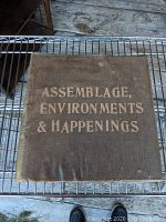 Front cover of the art book "Assemblage, Environments & Happenings" showing title text in white on brown cloth with visible surface wear and some staining.