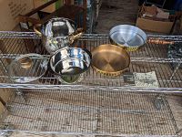 Photo of stainless steel steamer/double boiler with lid, brass chafing dish pan and liner, and chafing dish cookery booklet placed on metal rack.