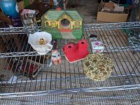 Top view of lot showing cottage clock, sugar bowl, Viewmaster, red plastic holder, floral trinket box and coaster set