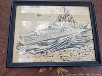 Framed monochrome art with USS Mitscher DL-2 ship depiction and signed handwritten inscription.