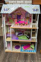 Front view of the full doll house showing all three floors with furniture