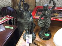 Front view of both cast iron statues side by side