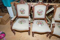 front view of two carved wood Eastlake armchairs side by side
