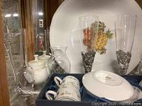 Photo showing two champagne flutes with pewter bases, glass vase with pewter design, and the espresso cups in their box with blue satin lining.