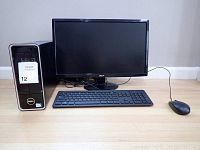 Dell desktop tower, Acer monitor, wired keyboard, and mouse arranged on a light wood floor against a white wall.