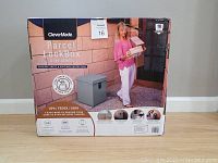 Full front view of the CleverMade Parcel LockBox S100 Series in its retail box showing package theft and weather protection features.