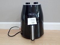 Front view of black Bella air fryer showing brand name and control dials on top.